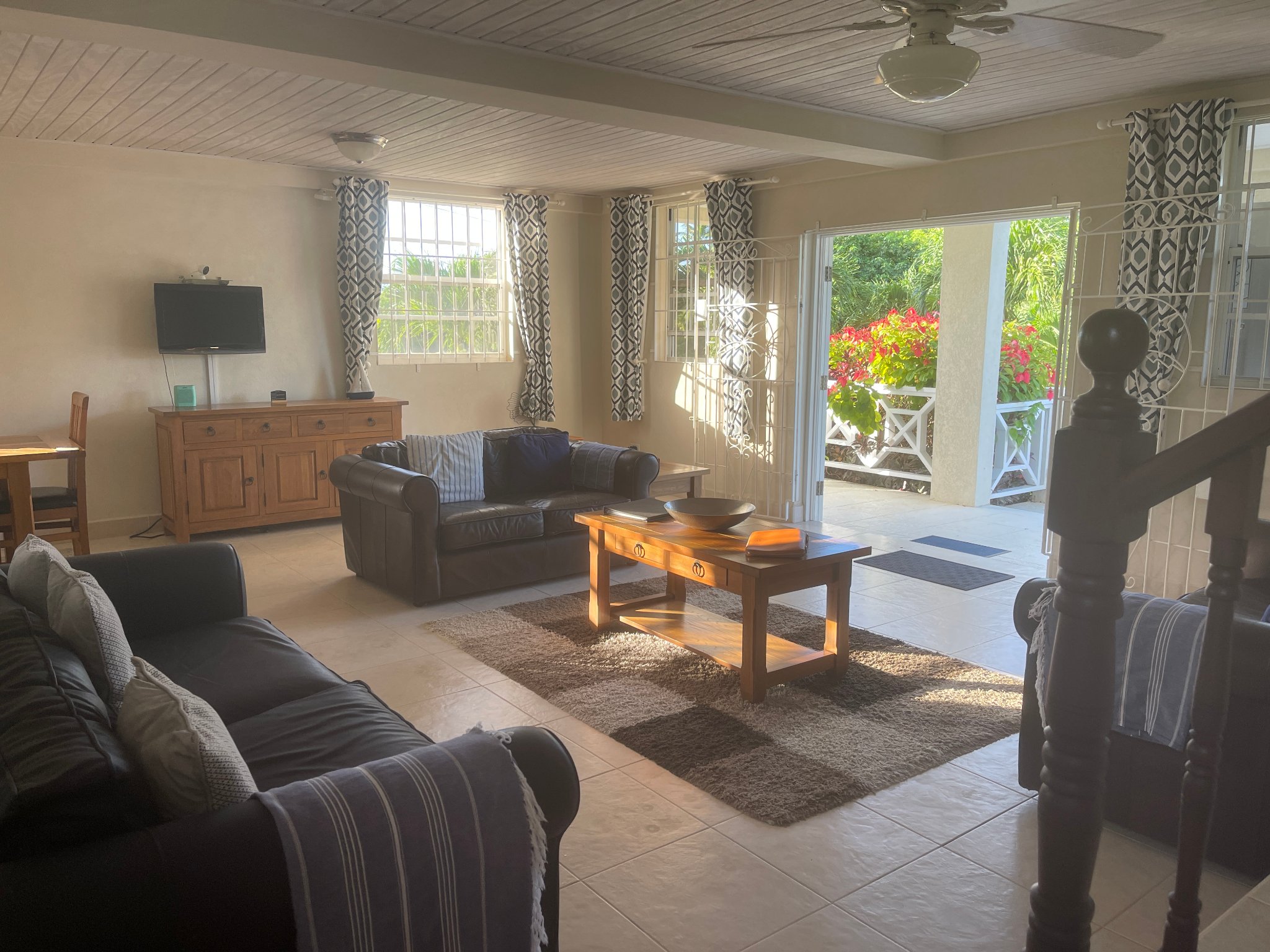 Holland Park Villa spacious lounge with sofas, staircase and garden doors
